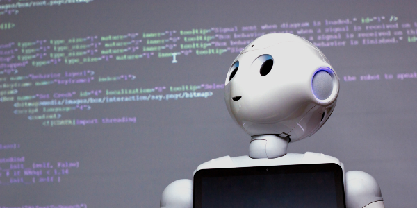 Karel, the social robot, standing in front of code